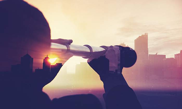 Business man in suit with cityscape montage.